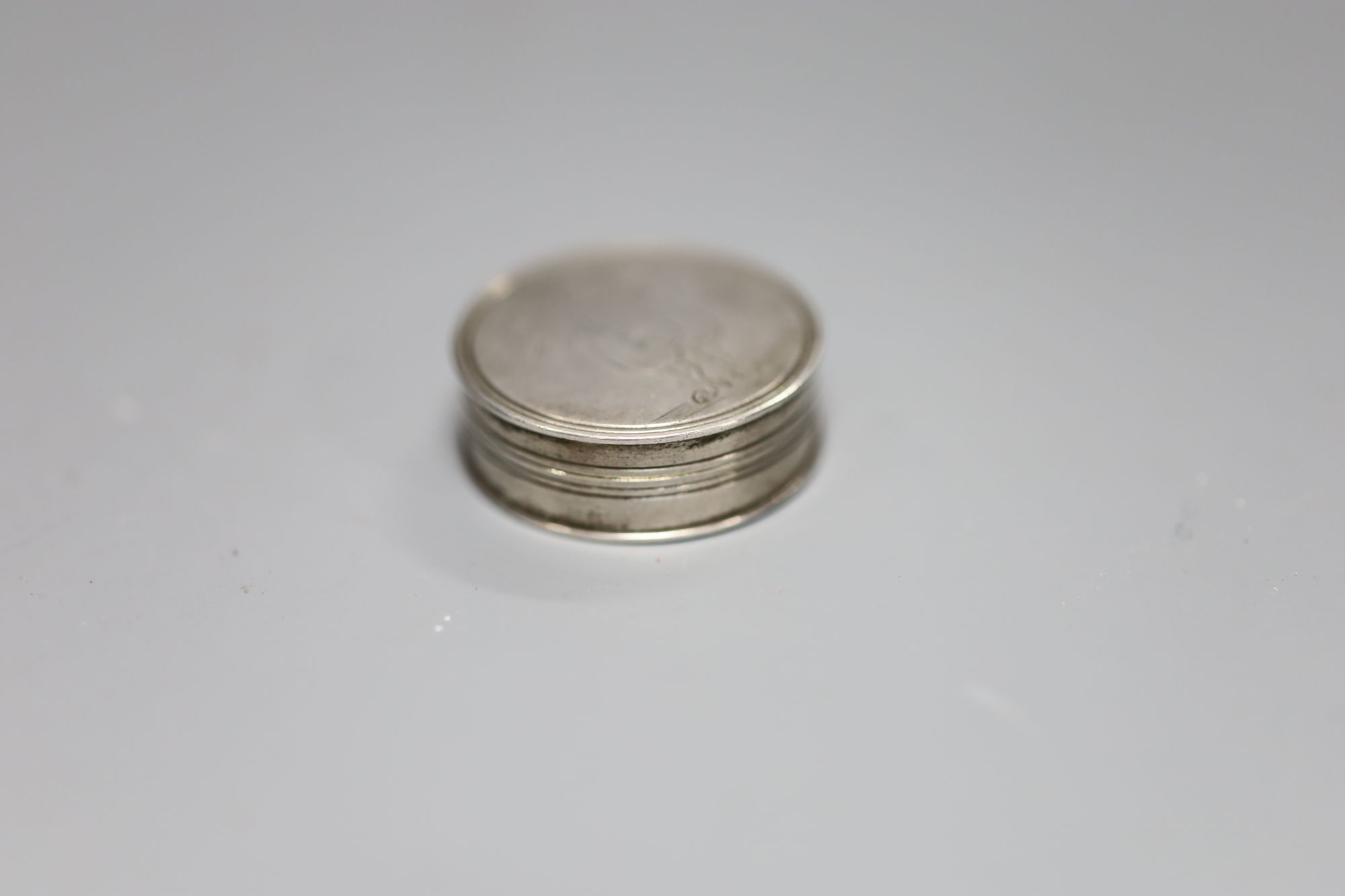 A George III silver circular vinaigrette with erotic engravings (faint), Joseph Ash I, London, 1808, 28mm.